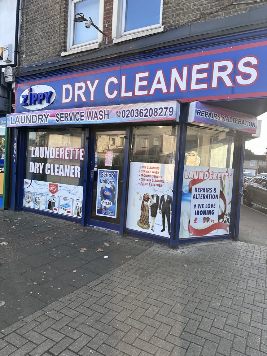 Daytime view of the New Zippy Dry Cleaners & Launderette shopfront in East Ham with service signage in the windows